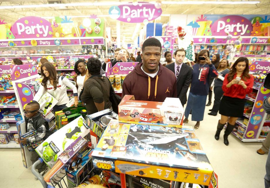 andre johnson with shopping cart full of toys 