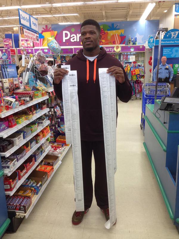 andre johnson holding receipts post shopping spree