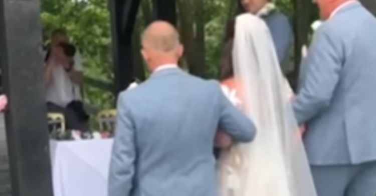 A dad and stepdad walk their daughter down the aisle.