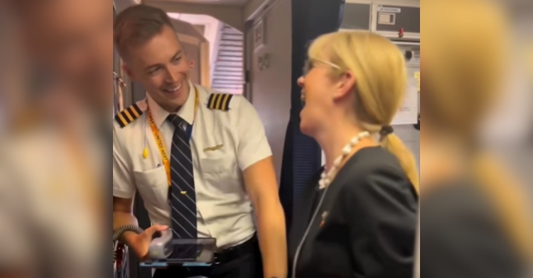A pilot smiles as he looks over at his flight-attendant mom who looks happily surprised.