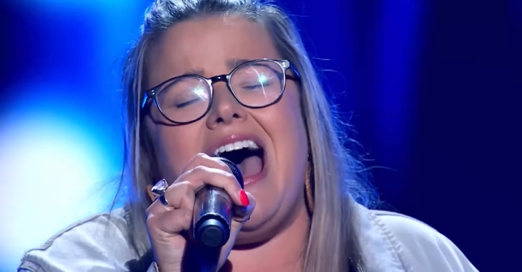 Close up of Elly singing passionately on "The Voice Australia." Her eyes are closed and she's belting out a long note.