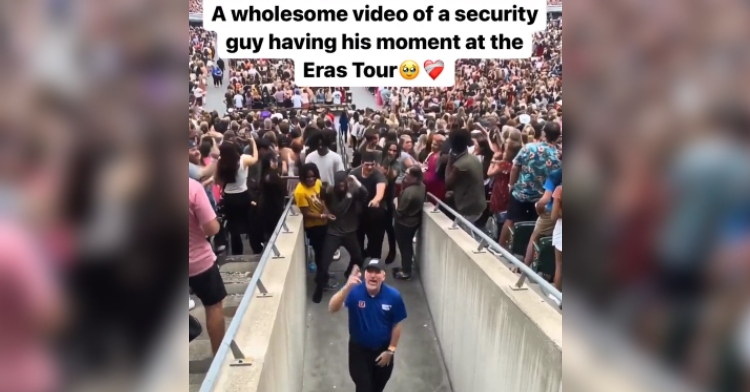 View from above of a security guard dancing at Taylor Swift’s Eras Tour concert in Cincinnati. A nearby group watch and hype him up.