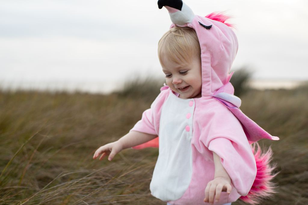 A little girl loves her adorable costume. 