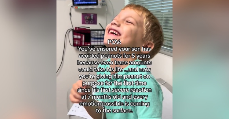 A little boy sits in a doctor's room, smiling wide. Text on the screen reads: "POV: You’ve ensured your son has avoided peanuts for 5 years because even trace amounts could take his life… and now you’re giving him peanut on purpose for the first time since his first severe reaction at 7 months old and every emotion possible is coming to the surface."