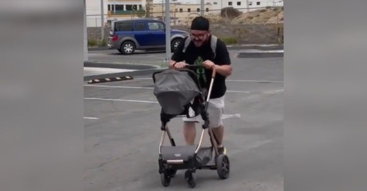 dad pushing stroller in parking lot