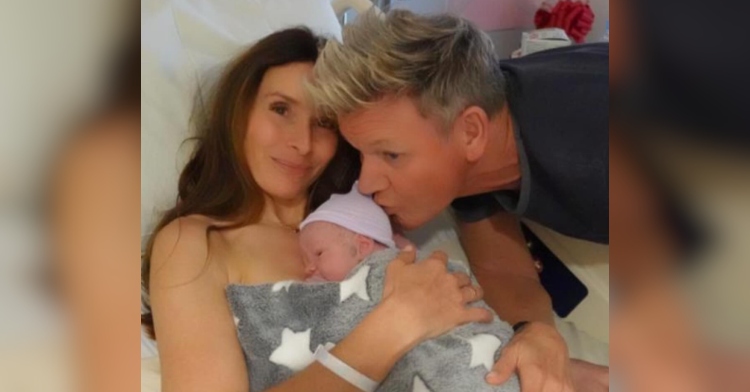 Tana Ramsay smiles from a hospital bed, holding her newborn son, Jesse James Ramsay, to her chest. Gordon Ramsay leans over and kisses the newborn on the top of his head.