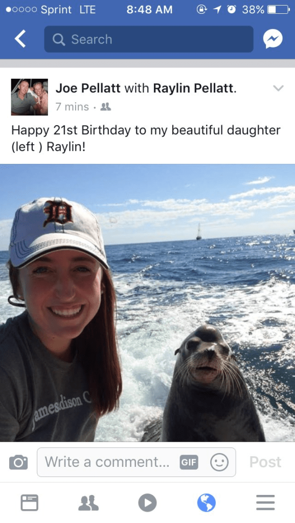 post of a woman posing next to a sea lion