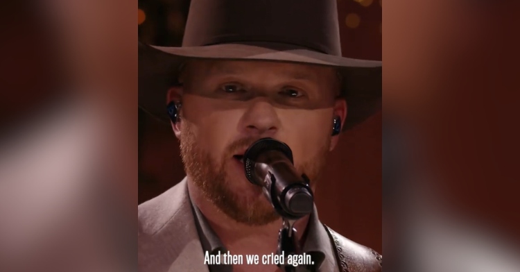 Close up of Cody Johnson talking into a mic. Text on screen reads: And then we cried again.