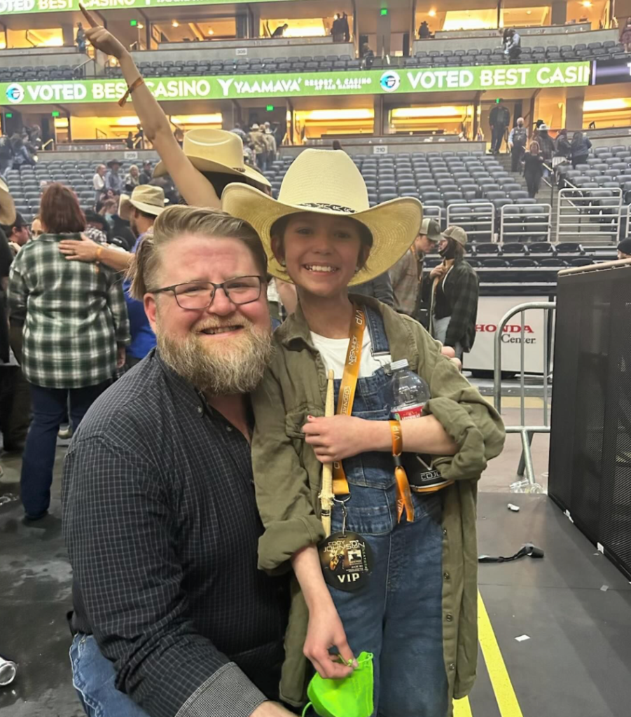 Little girl gets signed Cody Johnson hat.