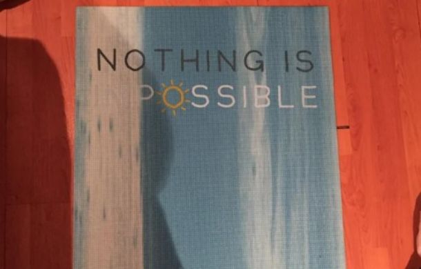 A motivation yoga mat that says "Nothing is Possible" because the font blends into the background design making the letters "IM" invisible.