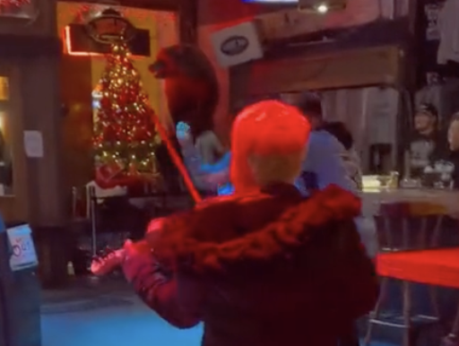 woman playing fiddle in a bar