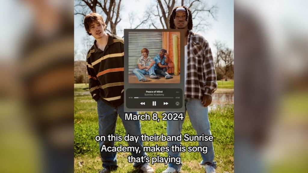 Two young men standing outside with a screenshot from a streaming platform.