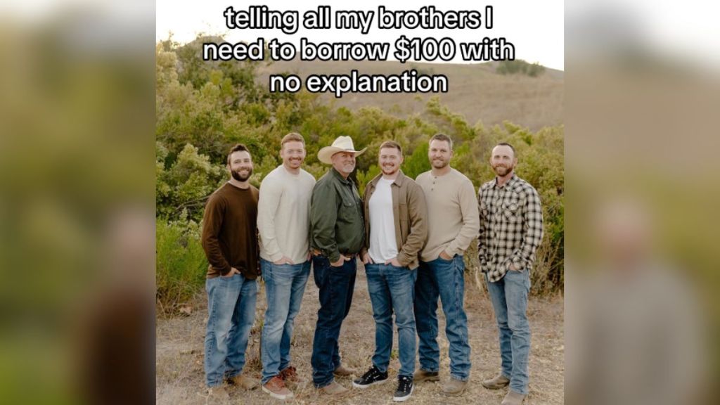 A father and five adult sons standing outdoors and smiling.