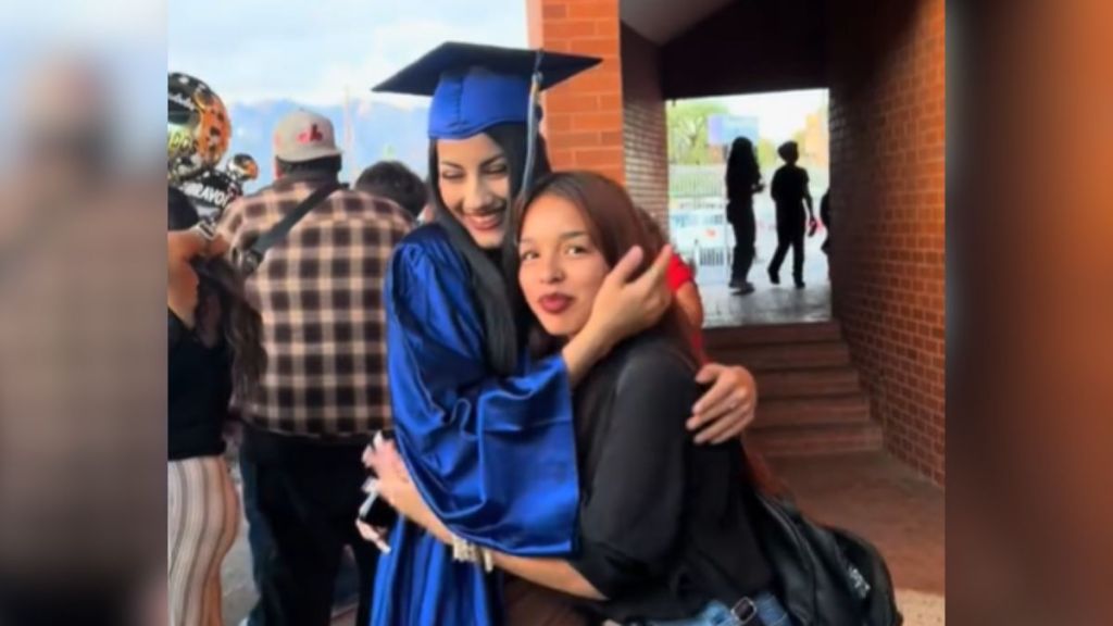A high school graduate hugging her best friend.