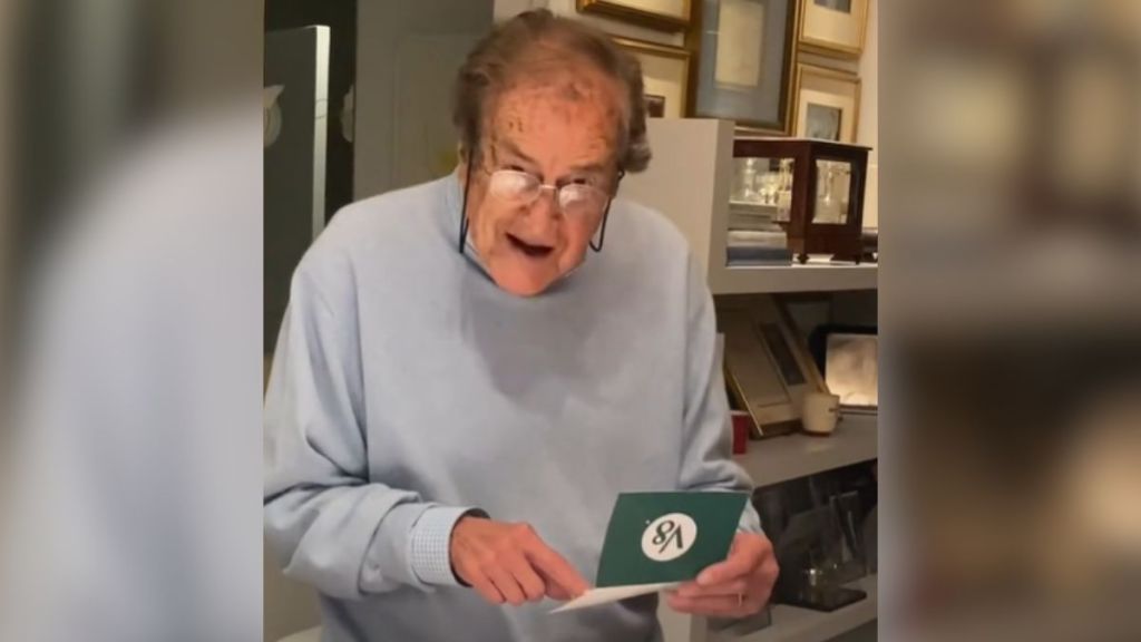 A grandpa reads a letter from V8 out loud and smiles.