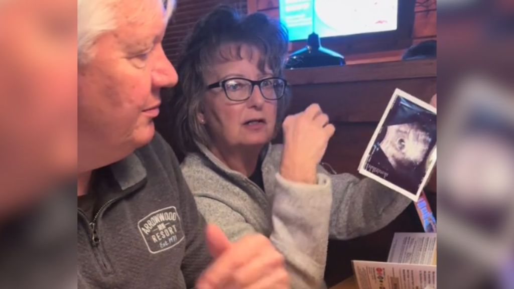 A grandma holds up an ultrasound photo she found in her menu.
