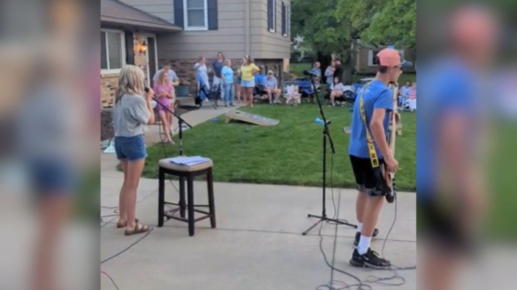 A group of kids playing rock music for their neighbors.