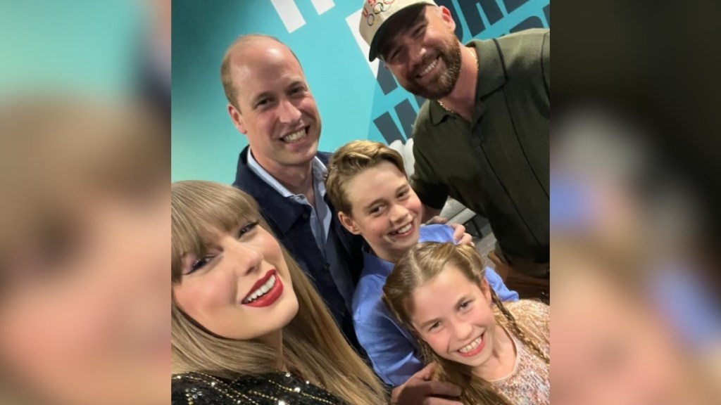 Taylor Swift smiles as she takes a selfie with Travis Kelce, Prince William, Princess Charlotte, and Prince George