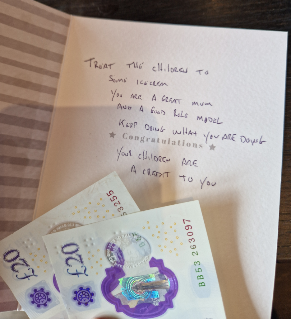 Inside of a card. There's cash at the bottom. The card itself says "congratulations." The following is handwritten on the card: Treat the children to some ice cream. You are a great mum and a good role model. Keep doing what you are doing. Your children are a credit to you.