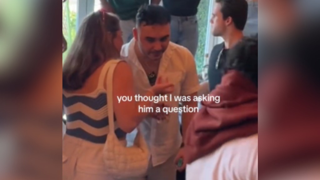 View from a distance of a woman leaning closer to talk to a man at a party. Text on the image reads: you thought I was asking him a question