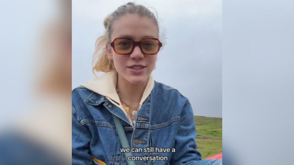 A young woman wearing sunglasses outdoors.