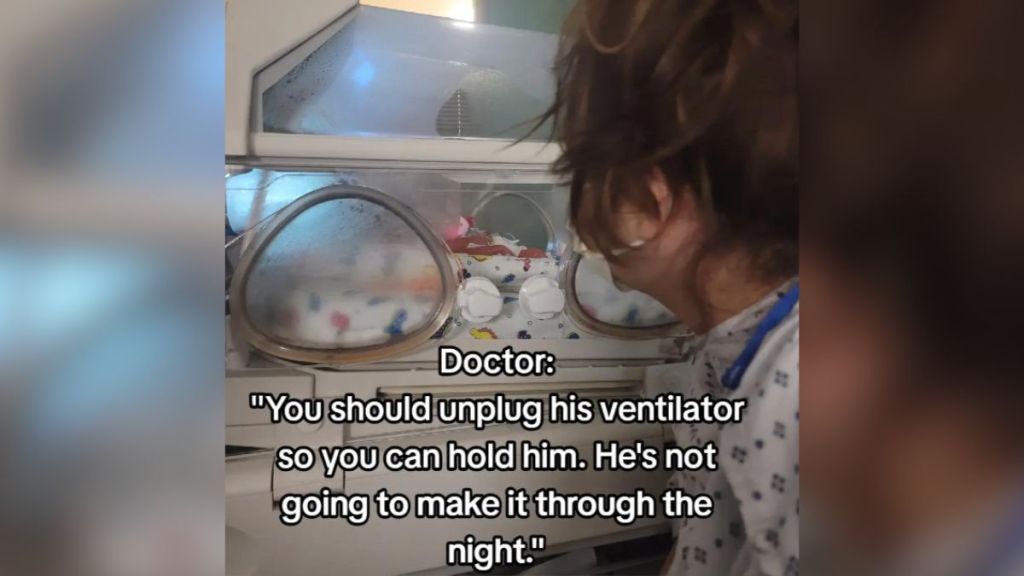 A mom watches her prematurely born baby in a ventilator.