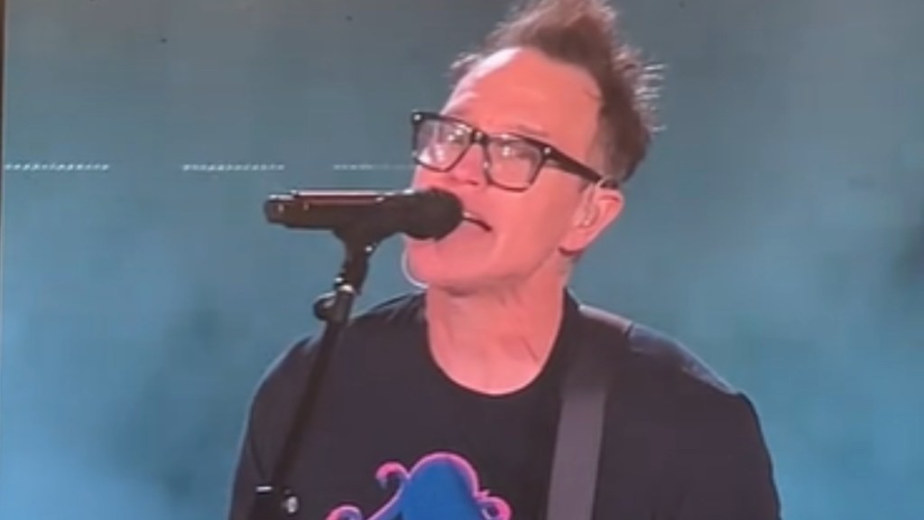 Close up of Mark Hoppus singing into a mic