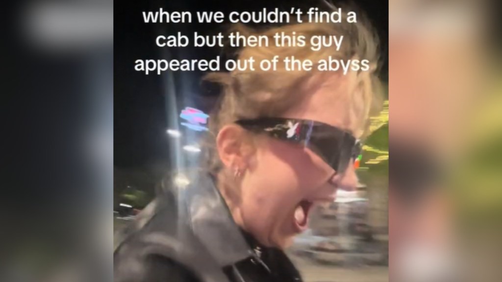 Close up of a woman with her mouth open wide, hair blowing in the wind. She's wearing sunglasses. Text on the image reads: when we couldn't find a cab but then this guy appeared out of the abyss