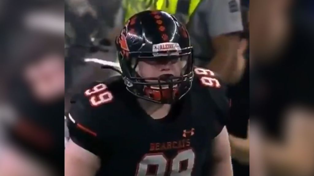 A teen with Down syndrome playing football.