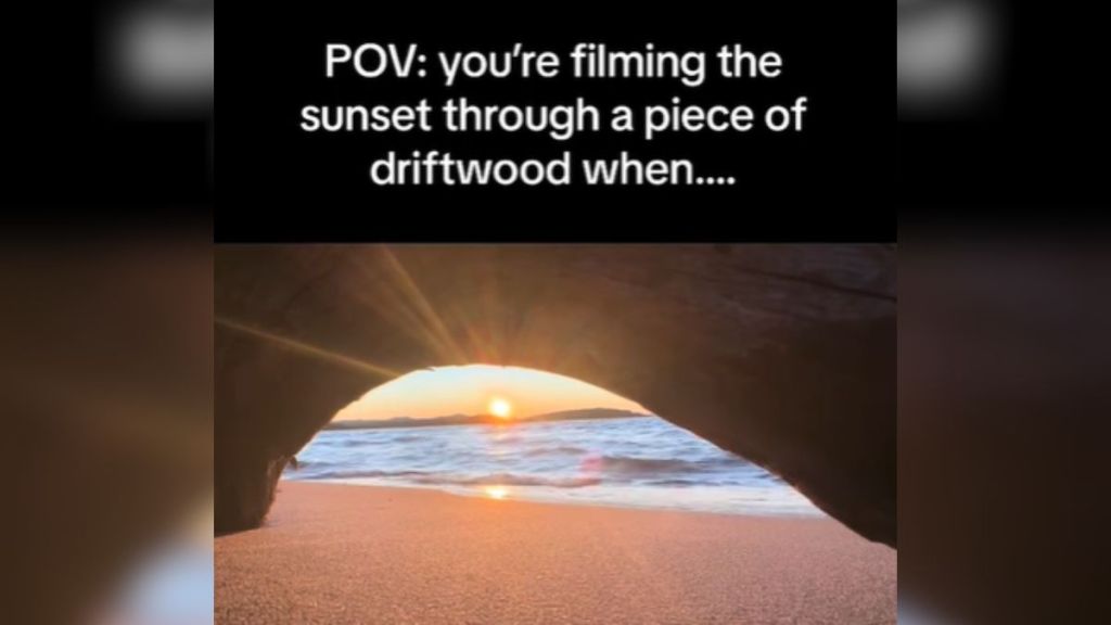 A sunset on the beach captured through an archway.