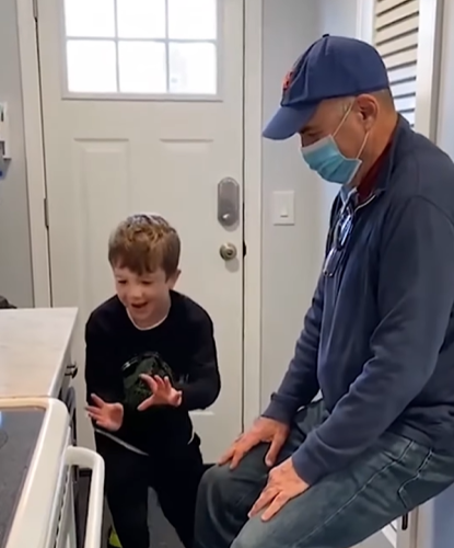 As the adults watch, the boy tries to use magic to open the drawer. 