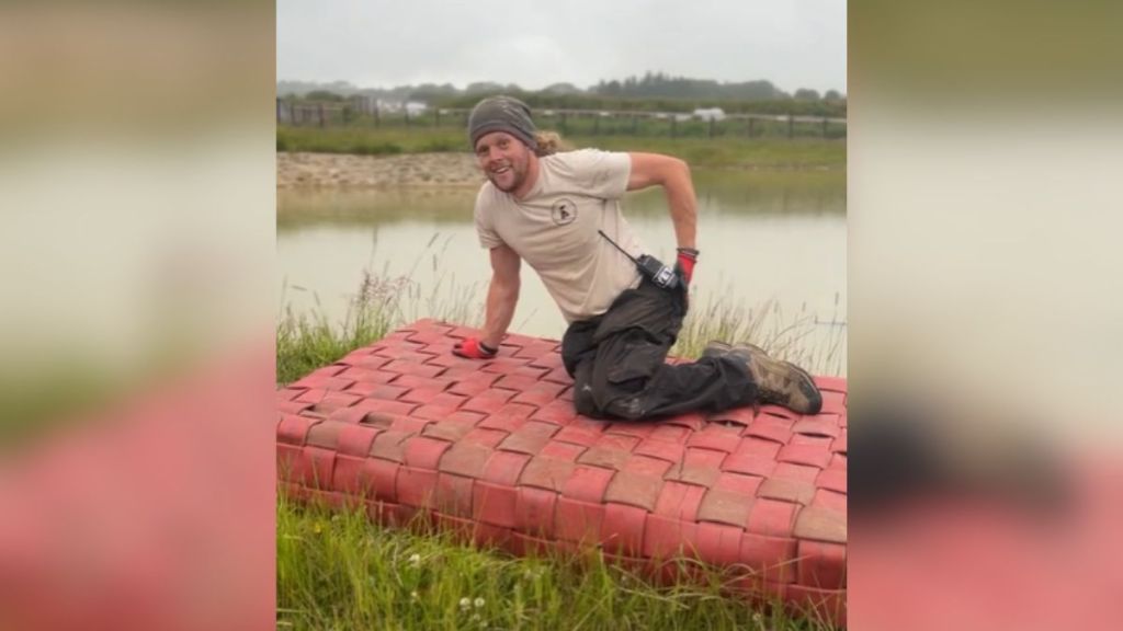 A man laying on a raft that he made.