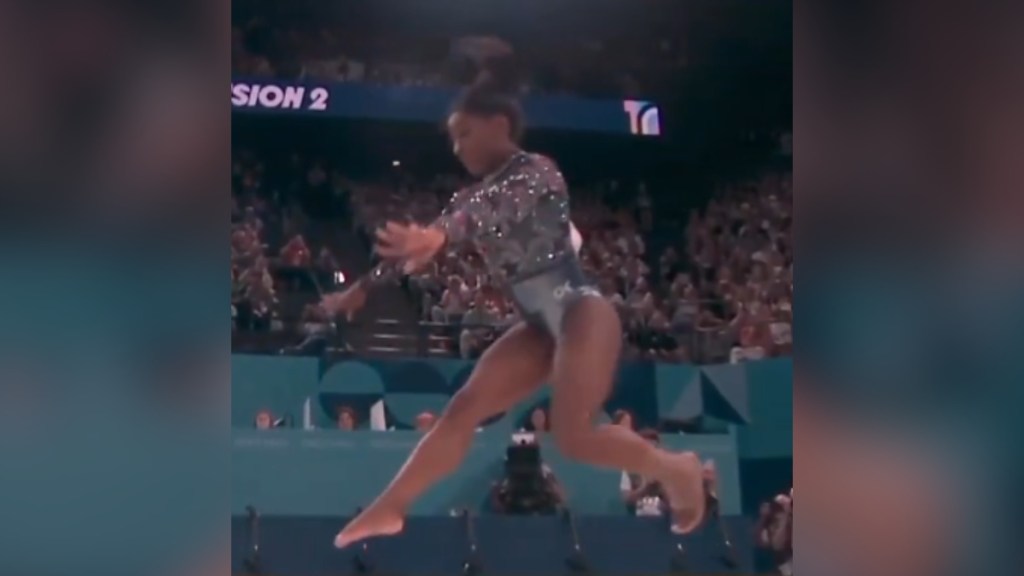 Simone Biles mid-air during a routine in the Paris Olympics