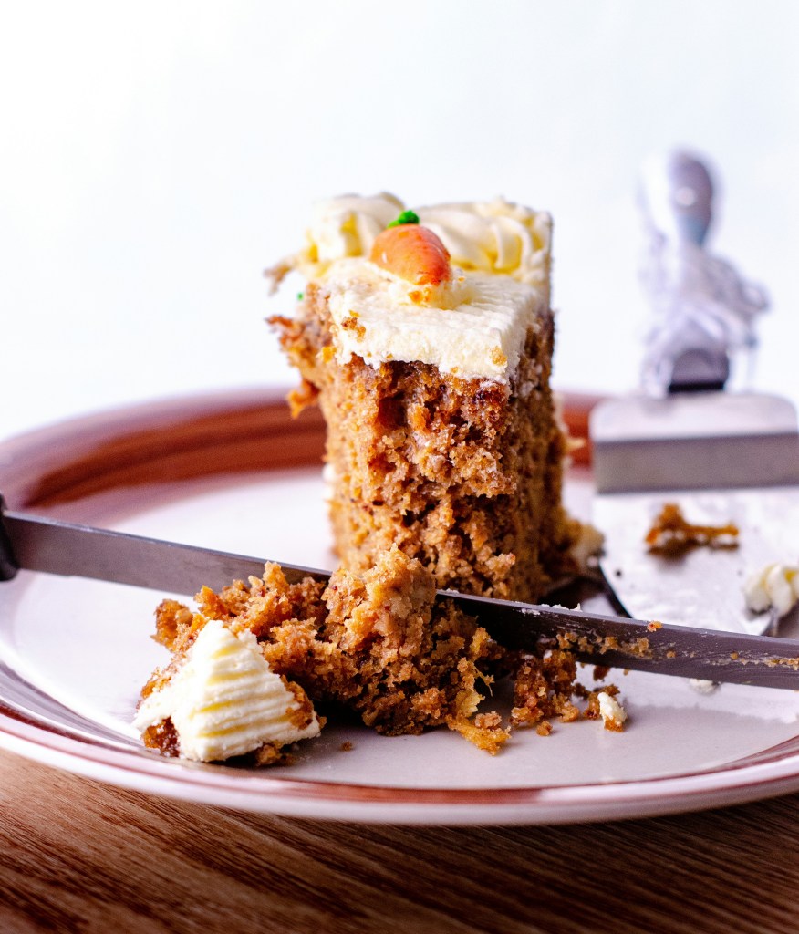 Close up of a half-eaten slice of carrot cake