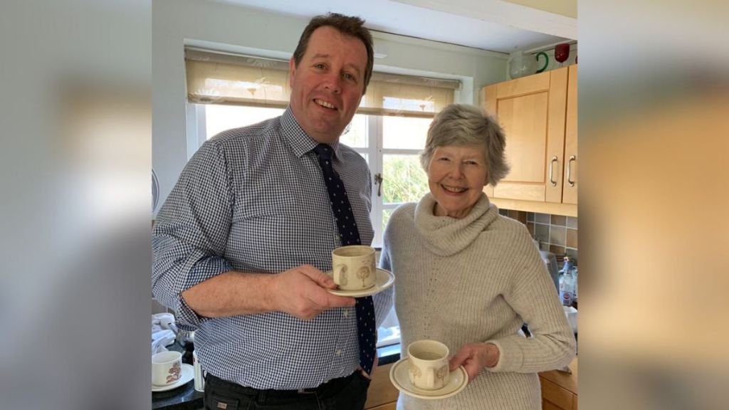 Image shows Sir Marc Spencer and Margaret Cooper sharing a cuppa tea to celebrate her ongoing work with Nottinghamshire Wildlife Trust to enable toad road closures.