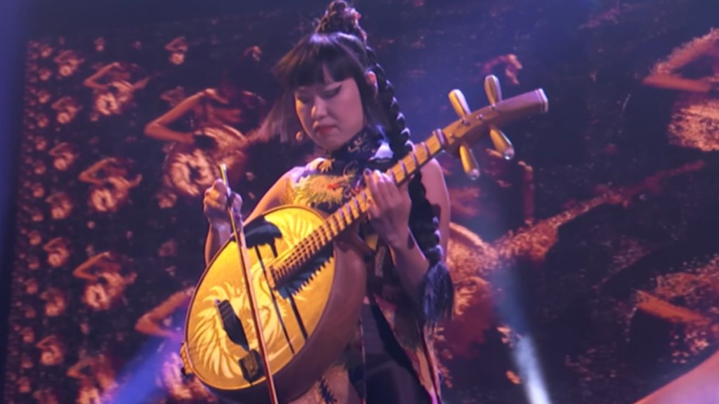 Close up of a woman playing a traditional Chinese instrument on "AGT"