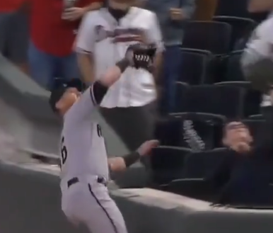 baseball player running to catch ball