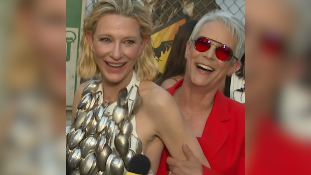 Cate Blanchett smiles as she stands closely in front of a smiling Jamie Lee Curtis.