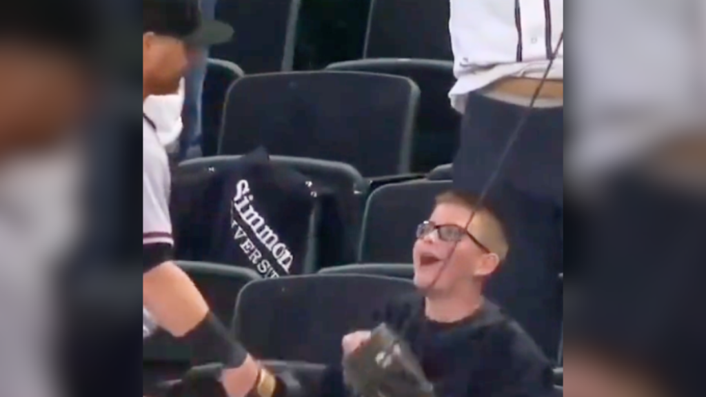 kid and baseball player smiling