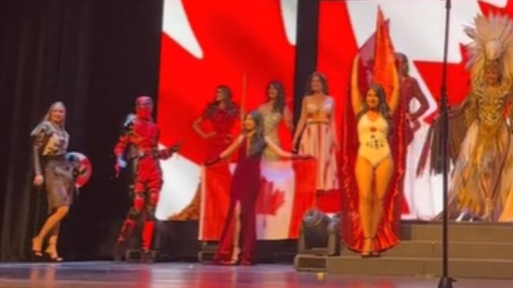 Stage of Miss Universe Canada contestants. "Deadpool" is with them.