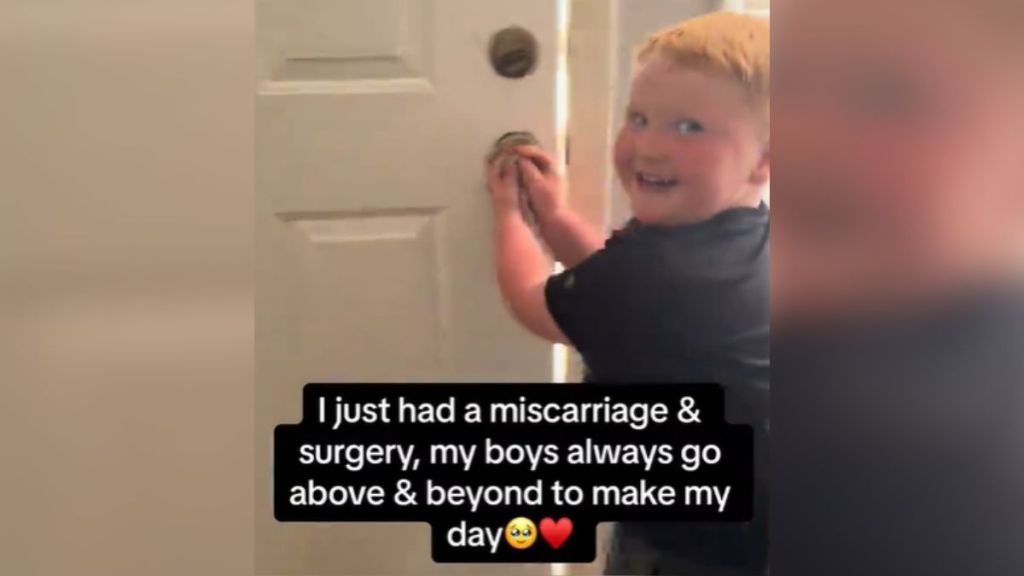 A little boy looks excited while opening a door.