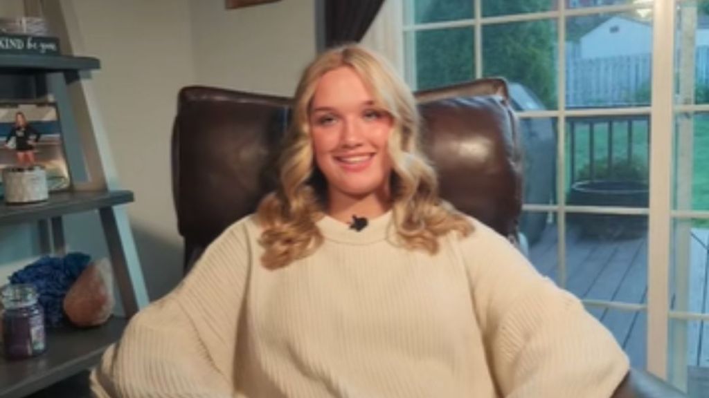 A blonde teenage girl sitting in a chair.