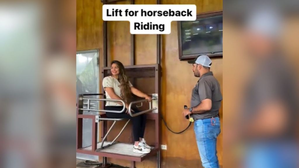 A woman sitting on an accessible lift.