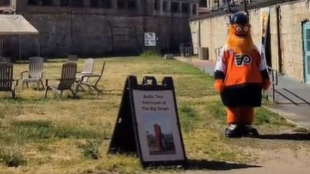 Image shows Philadelphia Flyers mascot Gritty waiting to audition for the haunted attraction at Eastern State Penitentiary.