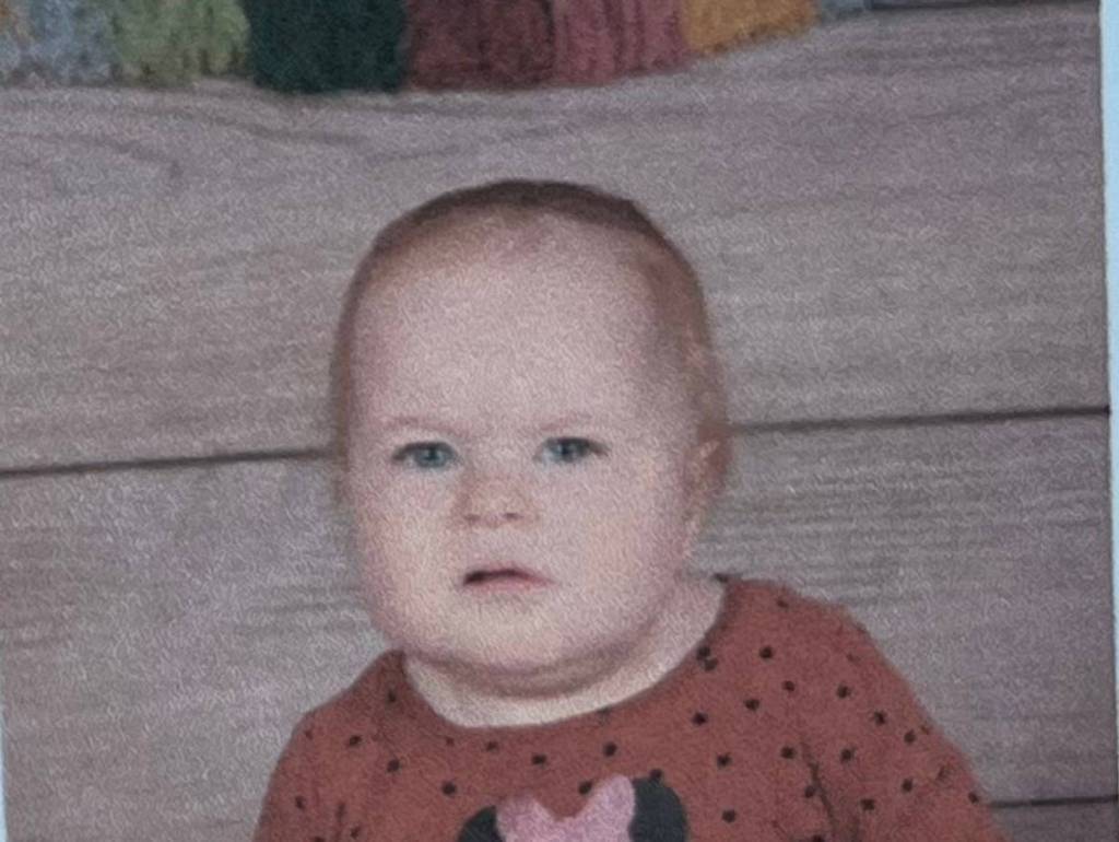 Close up of a confused looking baby, her face scrunched up as if thinking hard