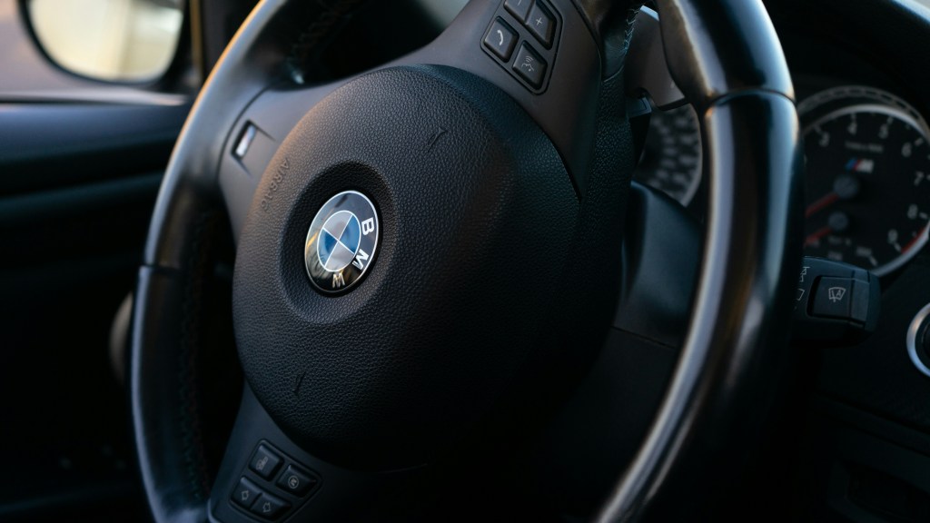 a close up shot of a bmw steering wheel