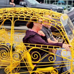 man and woman in volkswagen beetle made of iron