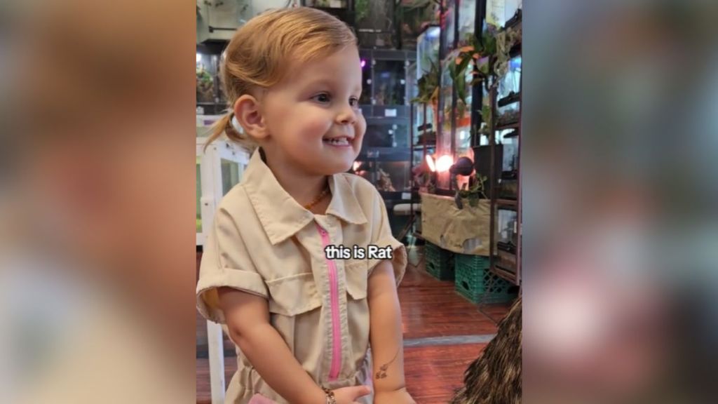 A little girl smiling in a pet store.