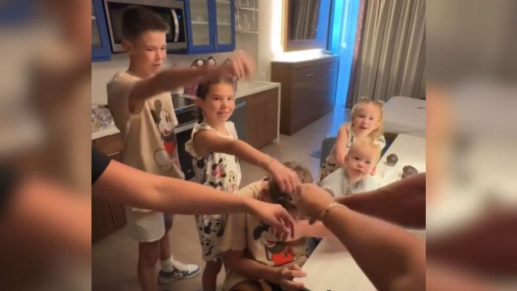 Image shows a family doing a "hands in" rally cry after a pep talk from Dad about visiting Disney parks.