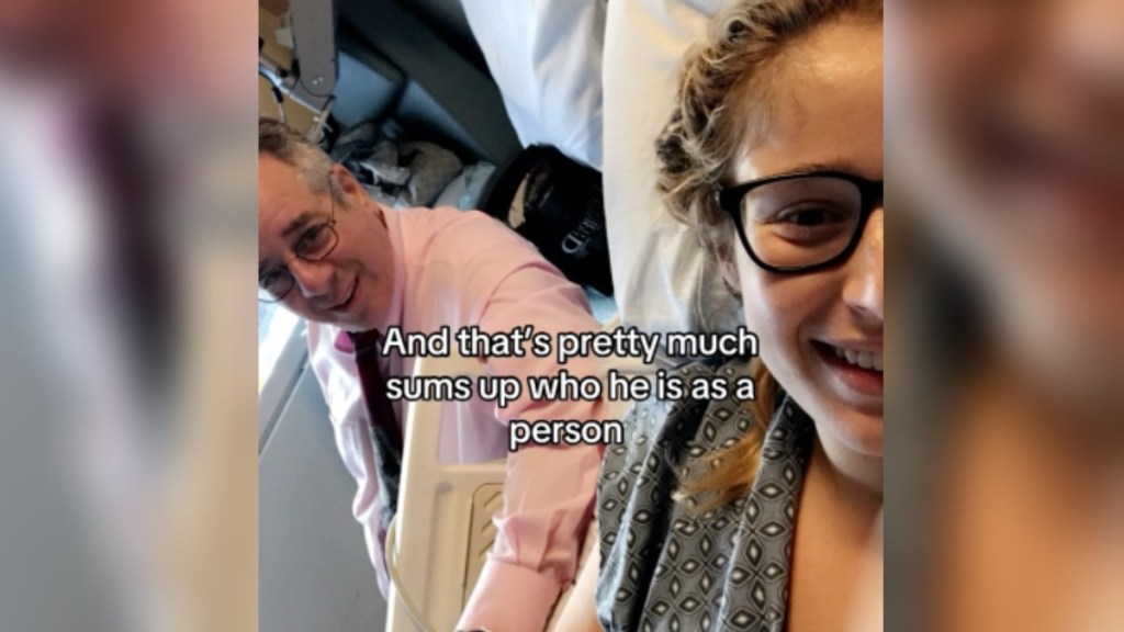 A woman, Jamie, takes a selfie with her dad. They're both smiling. She's laying in a hospital bed, and the image only captures half of her face. Text on the image reads: And that's pretty much sums up who he is as person